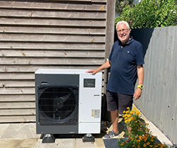 Photo of man beside heat pump