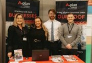 smiling exhibitors on their exhibition stand