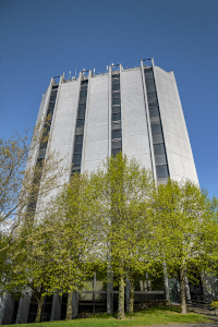 Civic offices building against a blue sky with trees in the foreground