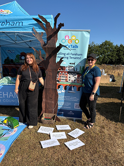 Fareham Council officers stood under a Lets Talk Fareham gazebo