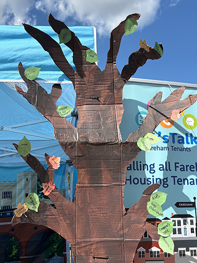 Cardboard tree in front of a Lets talk Fareham gazebo