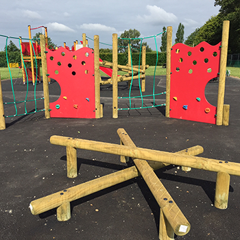 Park Land play area surrounded by trees with blue sky