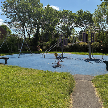 Sunlight gardens play area with trees in the background and blue sky