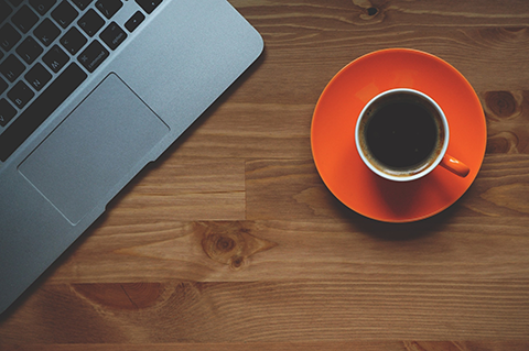 Image of laptop and coffee on table