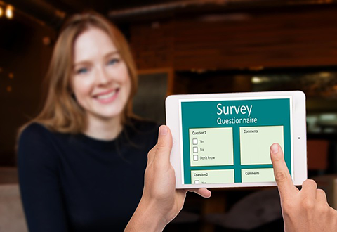 Photo of smiling woman taking survey