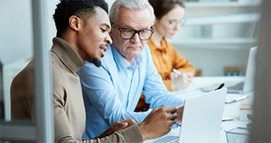 Two people looking at laptop