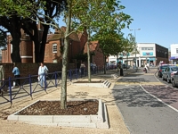 An image of the bus station showing newly surfaced pavements and newly planted trees.