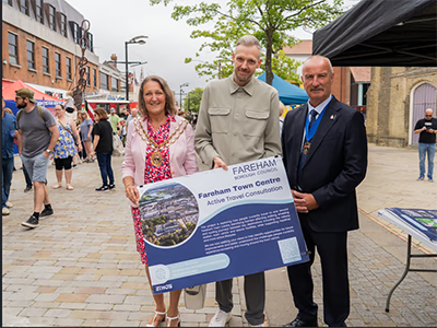 A photo of the mayor, mayor consort and a man holding a Fareham Town Centre Active Travel consultation poster