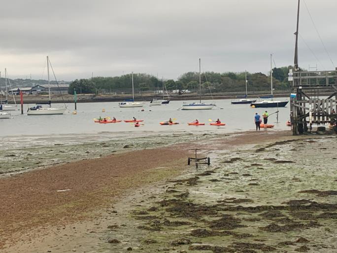 Photo of beach with kayaks on the water