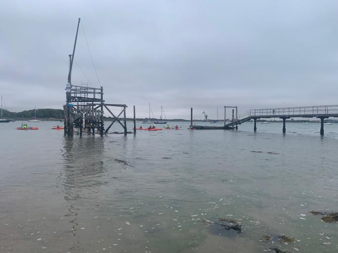 Photo of water with kayaks in the distance