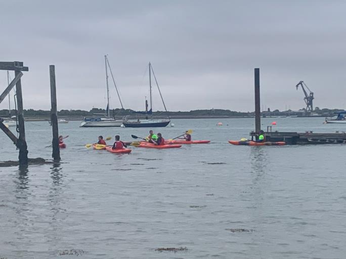 Photo of water with children in kayaks