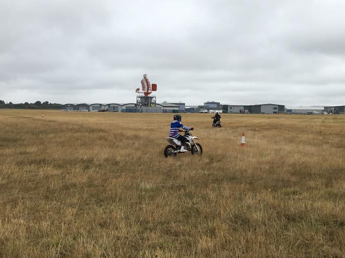 Photo of child on a motorcycle in a field