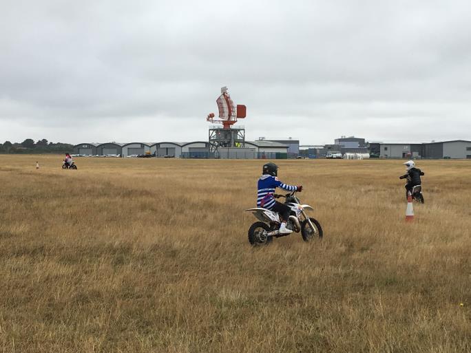 Photo of children on motorcycles in a field