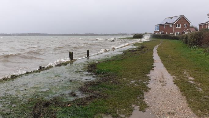 Image of tide close to path and house