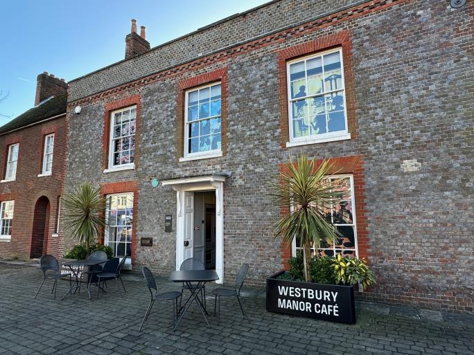 Westbury Manor exterior with signs
