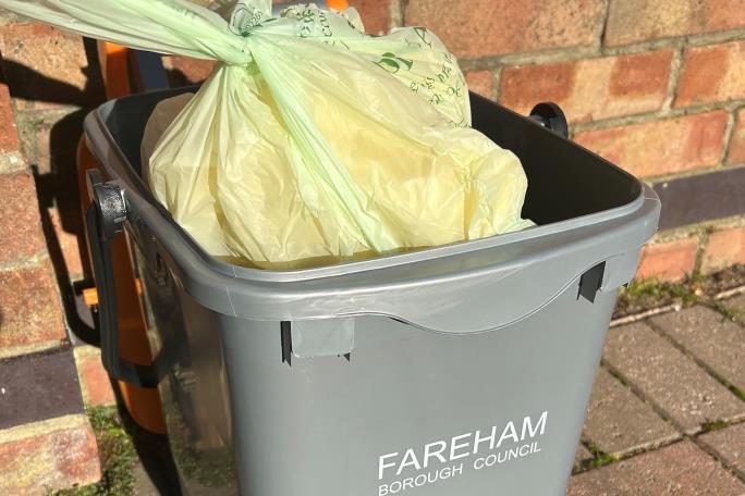 3. Empty your kitchen caddy into your outdoor food waste bin