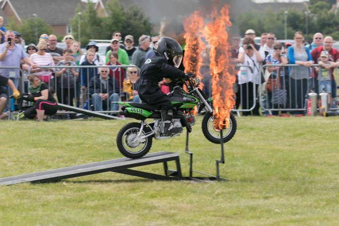 Motorbike jumping through ring of fire