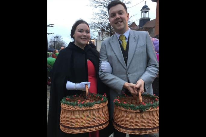 Two people with festive gift baskets
