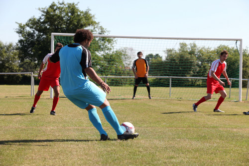 This is an image of a footballer scoring a goal