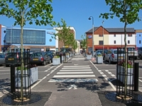 An image of the Markwt Quay car park running from front to rear of the picture and with one tree either side of the crossing in the foreground.
