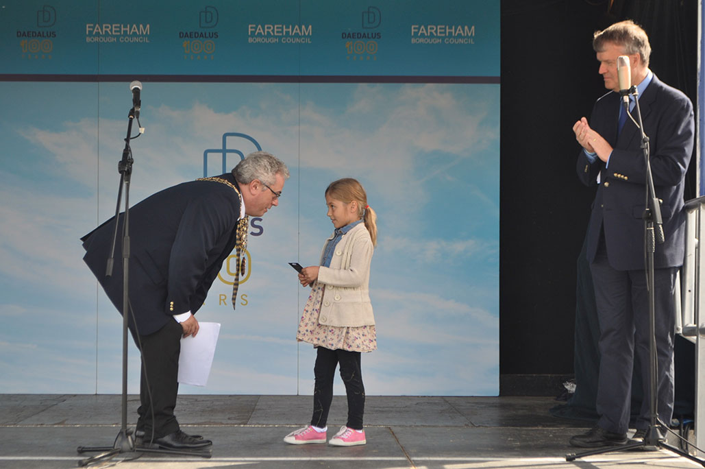 Mayor speaking to young child