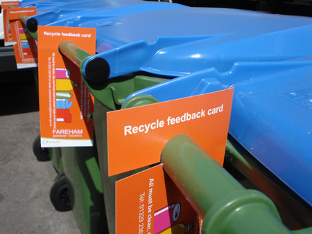 Red hangers on recycling bins