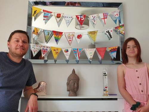 Anthony (father) and Lily (daughter) with the bunting they designed