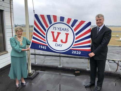 The Mayor of Fareham, Cllr Pamela Bryant, and the Executive Leader, Cllr Seán Woodward, raising the VJ Day flag